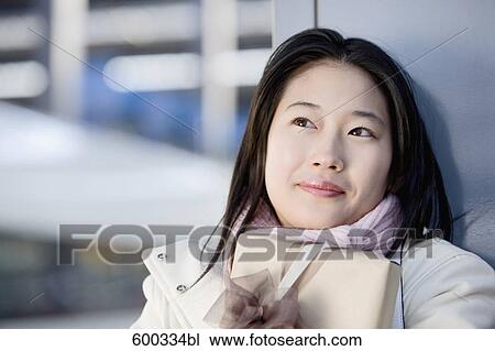 portrait of young japanese woman waiting with present at train station View Large Photo Image Stock Image - portrait of young japanese woman waiting with present at train station. Fotosearch