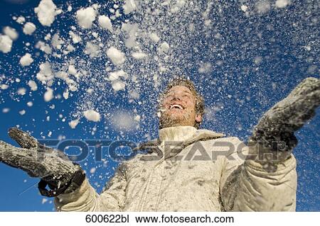 portrait of young man playing with snow View Large Photo Image Stock Image - portrait of young man playing with snow. Fotosearch