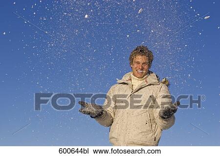 portrait of young man playing with snow View Large Photo Image Stock Image - portrait of young man playing with snow. Fotosearch