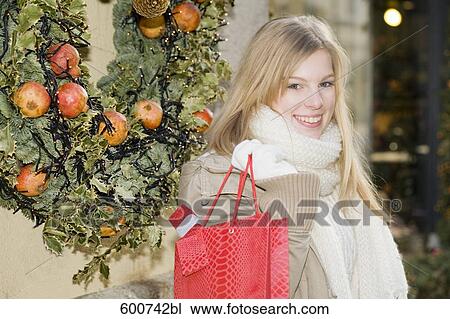 portrait of young woman carrying shopping bag View Large Photo Image Stock Image - portrait of young woman carrying shopping bag. Fotosearch