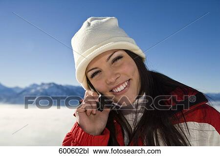 portrait of young woman in the mountains talking on mobile phone View Large Photo Image Stock Image - portrait of young woman in the mountains talking on mobile phone. Fotosearch