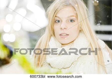 portrait of young woman looking through shop window with christmas decoration View Large Photo Image Stock Image - portrait of young woman looking through shop window with christmas decoration. Fotosearch