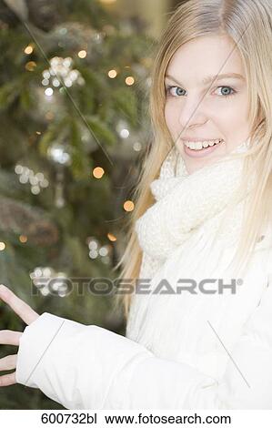 portrait of young woman standing at shop window View Large Photo Image Stock Image - portrait of young woman standing at shop window. Fotosearch