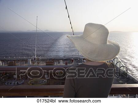rear view of woman on cruise ship looking at horizon sun is setting View Large Photo Image Stock Image - rear view of woman on cruise ship looking at horizon sun is setting. Fotosearch