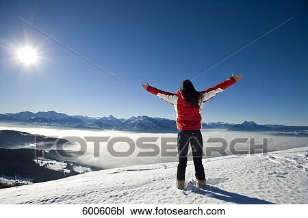 rear view of young woman in the mountains greeting sun View Large Photo Image Stock Image - rear view of young woman in the mountains greeting sun. Fotosearch