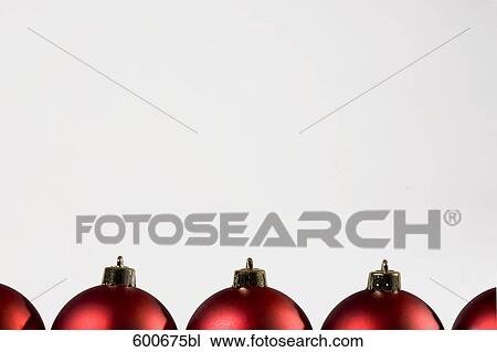 Stock Image - row of red christmas baubles. Fotosearch