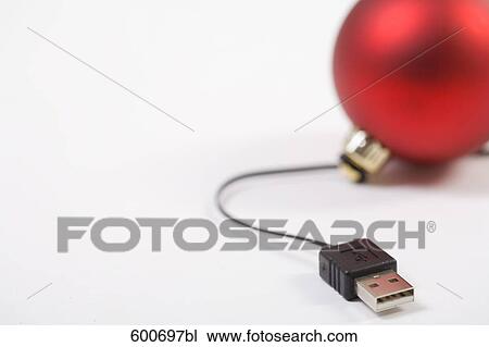Stock Image - still life of bauble connected to computer cable. Fotosearch