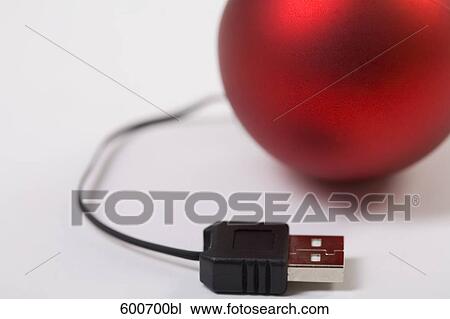 Stock Image - still life of bauble connected to computer cable. Fotosearch