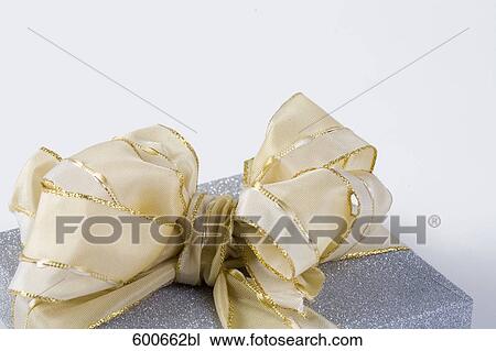 Stock Image - still life of blue present with white ribbon. Fotosearch