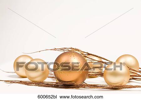 Stock Image - still life of golden baubles and twigs. Fotosearch