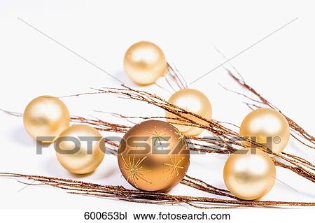 Stock Image - still life of golden baubles and twigs. Fotosearch