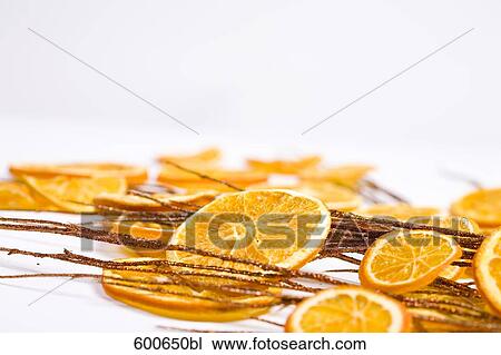 Stock Image - still life of orange slices and twigs. Fotosearch