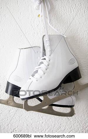 Stock Image - still life of pair of skates hanging on wall. Fotosearch