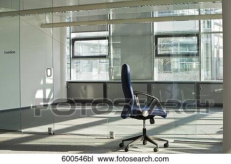 Stock Image - still of chair in empty office space. Fotosearch