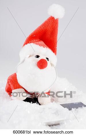 toy santa claus listening to music on ipod View Large Photo Image Stock Image - toy santa claus listening to music on ipod. Fotosearch