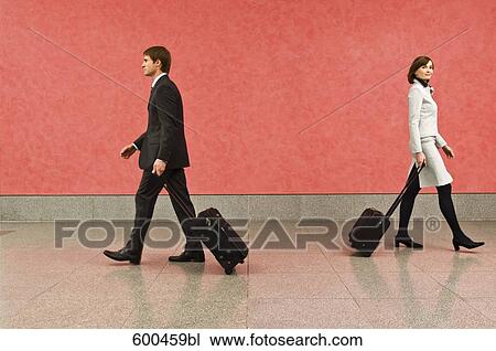 two business travellers in corridor pulling carry-on suitcases View Large Photo Image Stock Image - two business travellers in corridor pulling carry-on suitcases. Fotosearch