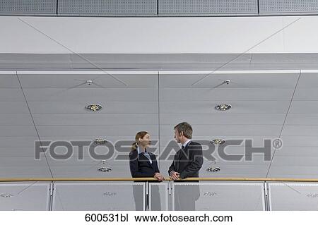 two executives having conversation in office building View Large Photo Image Stock Image - two executives having conversation in office building. Fotosearch