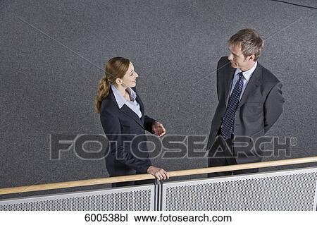 two executives having conversation in office building View Large Photo Image Stock Image - two executives having conversation in office building. Fotosearch