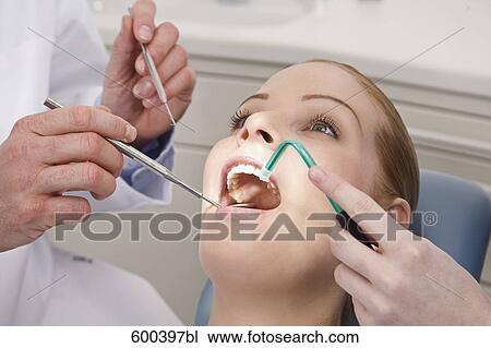 Stock Image - woman being examined by dentist. Fotosearch