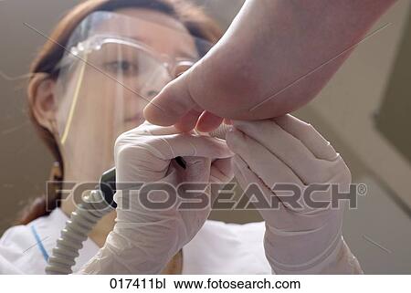 Stock Image - woman undergoing medical treatment of her feet. Fotosearch