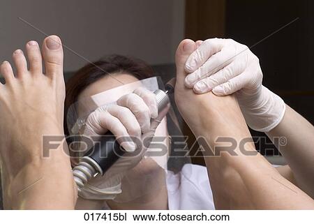 Stock Image - woman undergoing medical treatment of her feet. Fotosearch