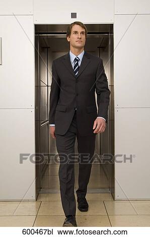 young businessman leaving elevator View Large Photo Image Stock Image - young businessman leaving elevator. Fotosearch