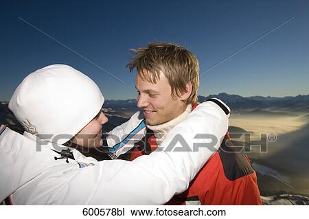 Stock Image - young couple in the mountains tenderly looking at each other. Fotosearch