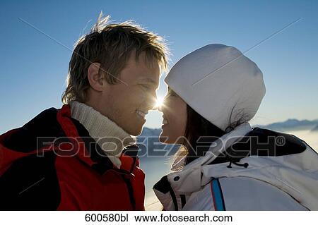 young couple in the mountains tenderly looking at each other View Large Photo Image Stock Image - young couple in the mountains tenderly looking at each other. Fotosearch