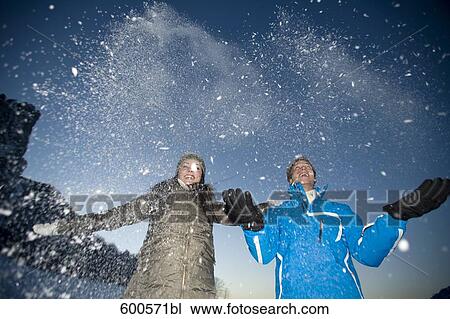 young couple playing with snow View Large Photo Image Stock Image - young couple playing with snow. Fotosearch