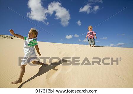 young girl and little brother running down sand dune View Large Photo Image Stock Image - young girl and little brother running down sand dune. Fotosearch
