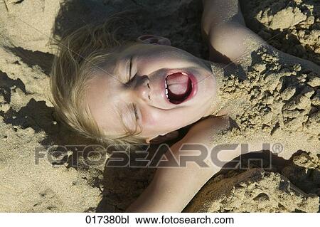 young girl buried under sand on beach View Large Photo Image Stock Image - young girl buried under sand on beach. Fotosearch
