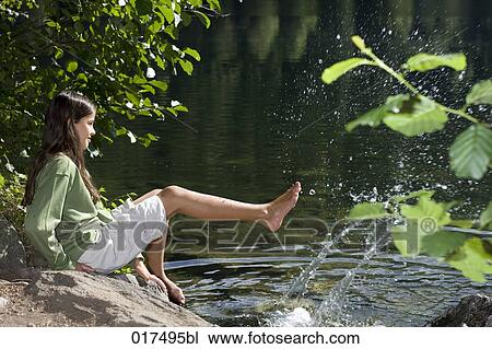 young girl cooling her feet in water in summer View Large Photo Image Stock Image - young girl cooling her feet in water in summer. Fotosearch