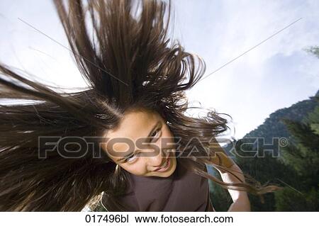 young girl swinging her long hair View Large Photo Image Stock Image - young girl swinging her long hair. Fotosearch