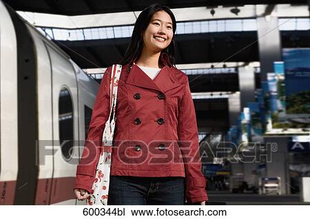 young japanese woman arriving at train station View Large Photo Image Stock Image - young japanese woman arriving at train station. Fotosearch