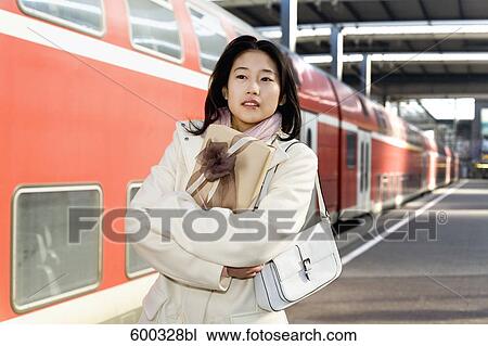 young japanese woman waiting with present at train station View Large Photo Image Stock Image - young japanese woman waiting with present at train station. Fotosearch
