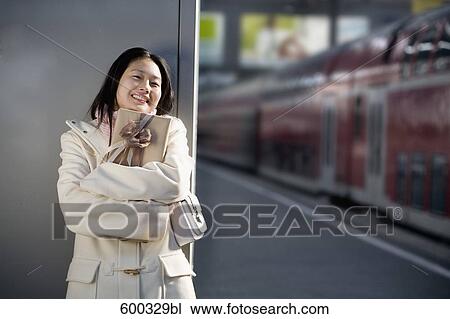 young japanese woman waiting with present at train station View Large Photo Image Stock Image - young japanese woman waiting with present at train station. Fotosearch