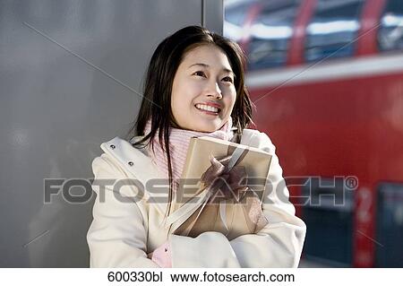 young japanese woman waiting with present at train station View Large Photo Image Stock Image - young japanese woman waiting with present at train station. Fotosearch