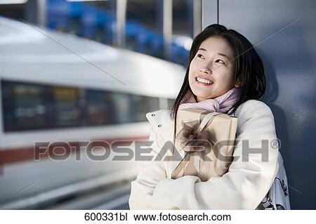 young japanese woman waiting with present at train station View Large Photo Image Stock Image - young japanese woman waiting with present at train station. Fotosearch