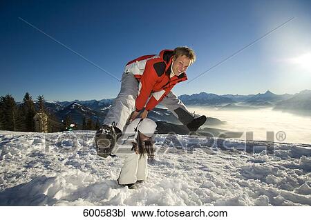 young man jumping over his girlfriend in the mountains View Large Photo Image Stock Image - young man jumping over his girlfriend in the mountains. Fotosearch