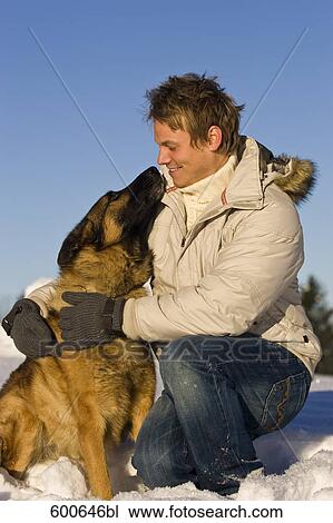 young man playing with german shepherd dog View Large Photo Image Stock Image - young man playing with german shepherd dog. Fotosearch