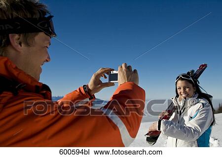young man taking picture of girlfriend in the mountains View Large Photo Image Stock Image - young man taking picture of girlfriend in the mountains. Fotosearch