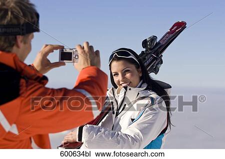 young man taking picture of girlfriend in the mountains View Large Photo Image Stock Image - young man taking picture of girlfriend in the mountains. Fotosearch