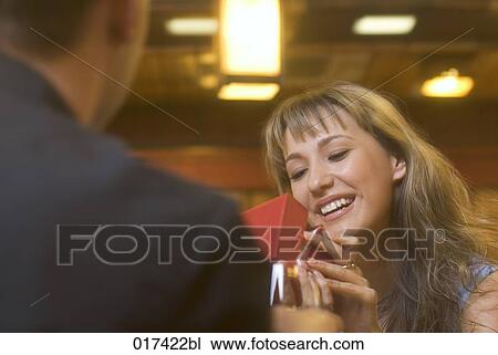 young woman getting present from boyfriend in restaurant View Large Photo Image Stock Image - young woman getting present from boyfriend in restaurant. Fotosearch