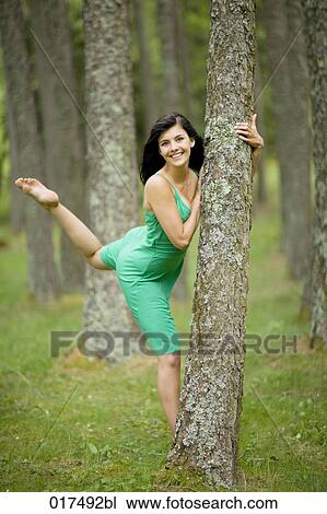 young woman in green summer dress dancing in forest View Large Photo Image Stock Image - young woman in green summer dress dancing in forest. Fotosearch
