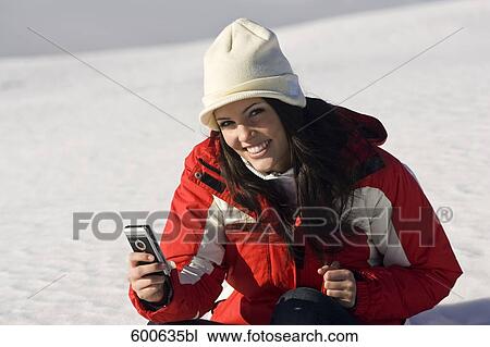 young woman in the mountains checking her mobile phone for text messages View Large Photo Image Stock Image - young woman in the mountains checking her mobile phone for text messages. Fotosearch