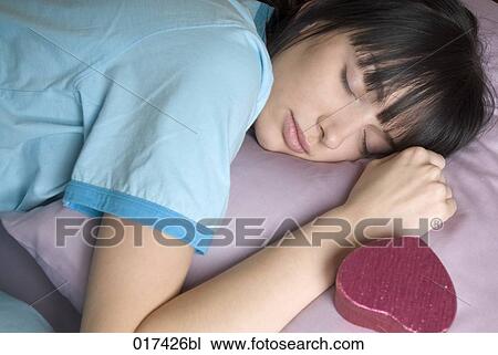 young woman sleeping with gift box by her side View Large Photo Image Stock Image - young woman sleeping with gift box by her side. Fotosearch