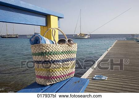 bag with towel and sunglasses on pier at marina View Large Photo Image Stock Image - bag with towel and sunglasses on pier at marina. Fotosearch