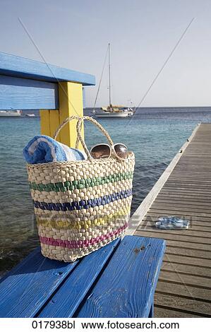 bag with towel and sunglasses on pier at marina View Large Photo Image Stock Image - bag with towel and sunglasses on pier at marina. Fotosearch