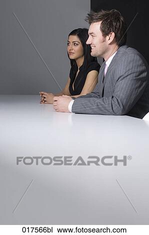 Stock Image - businessman and femal colleague following meeting. Fotosearch