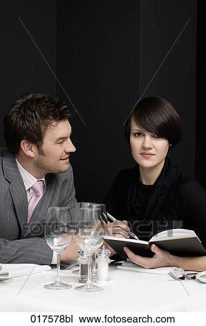 businessman and female colleague having business lunch View Large Photo Image Stock Image - businessman and female colleague having business lunch. Fotosearch